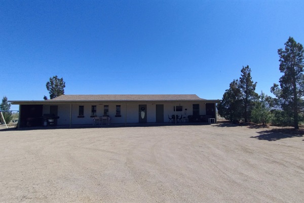 Relaxing and massive covered patio with dining space, seating, TV, grills, games and kids play area with swing set, cattle roping, basketball and more!!!