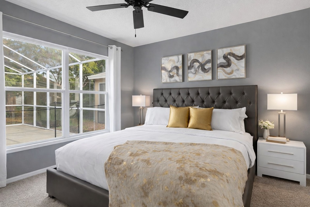 Modern KING bedroom with large window overlooking the pool area