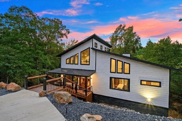Stunning exterior view of the modern cabin at sunset.