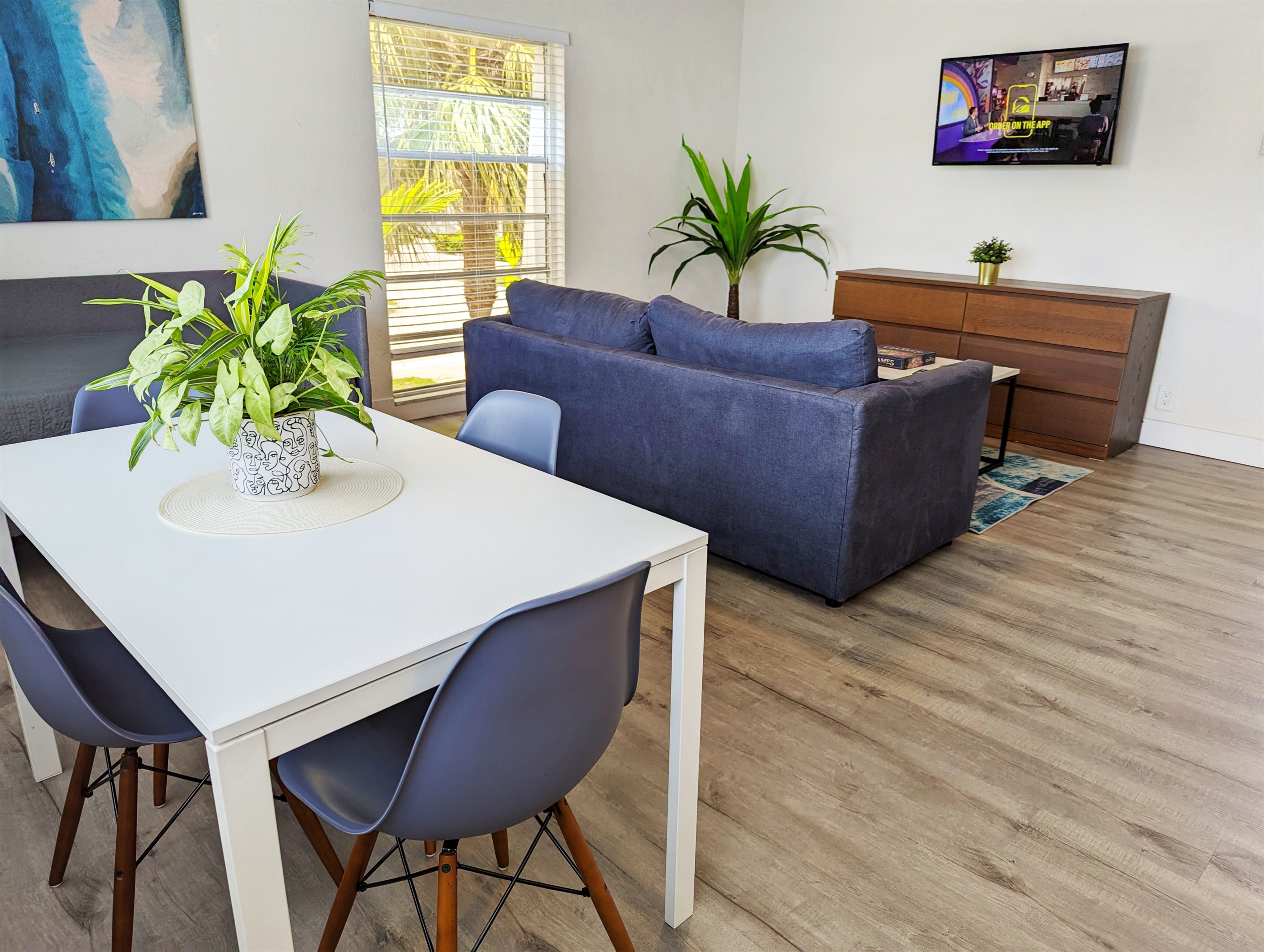 Featuring dining table that seats 4 with sofa and 40" smart TV