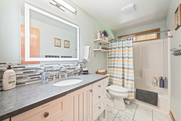 Bathroom #2 of 2: downstairs with LED mirror, large vanity and shower/tub combo