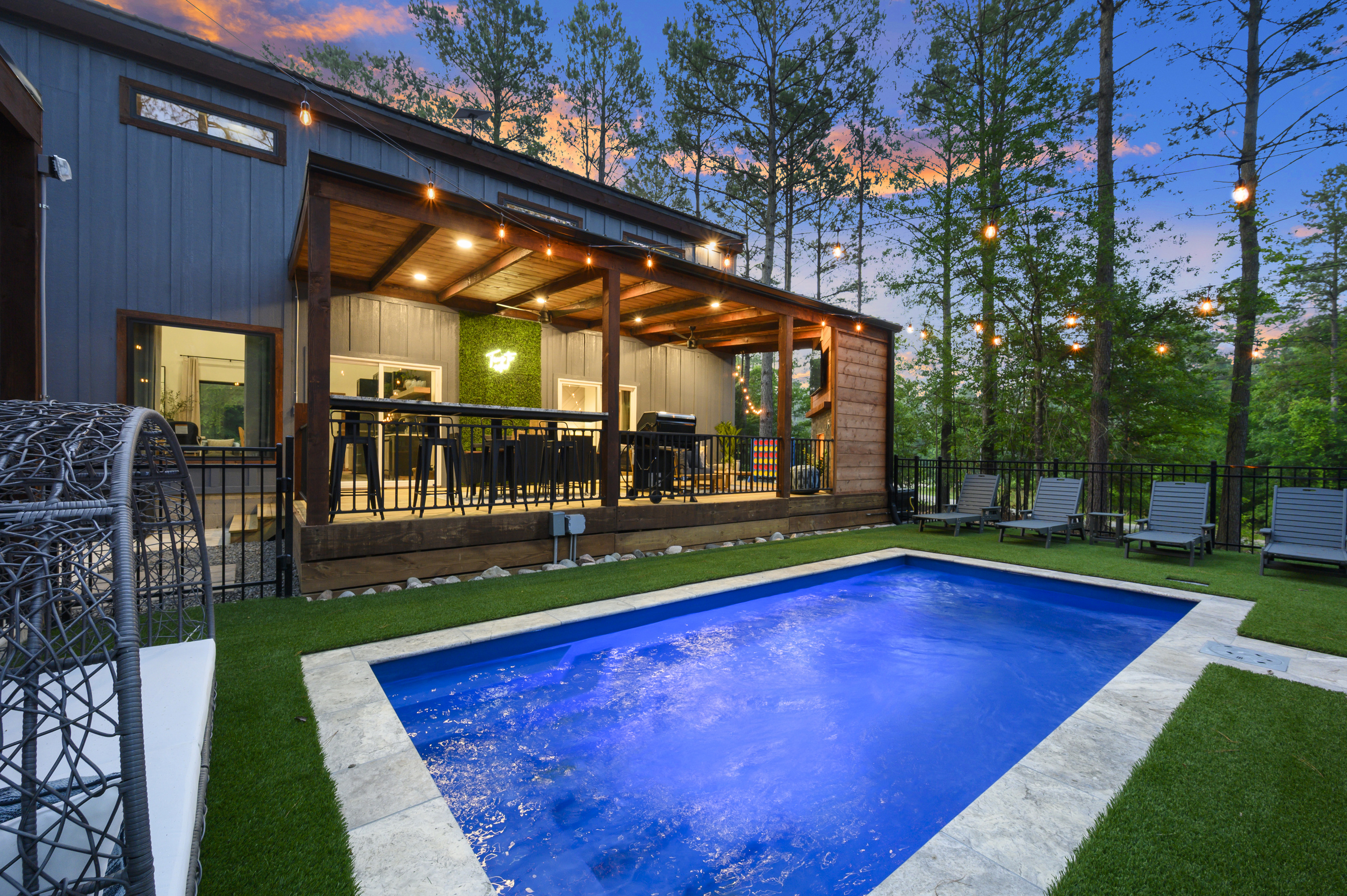 Your own private pool surrounded by towering pines, with loungers for pool days and a covered deck overlooking it all, perfect for grilling, dining and staying together between swims. Optional Pool Heating.
