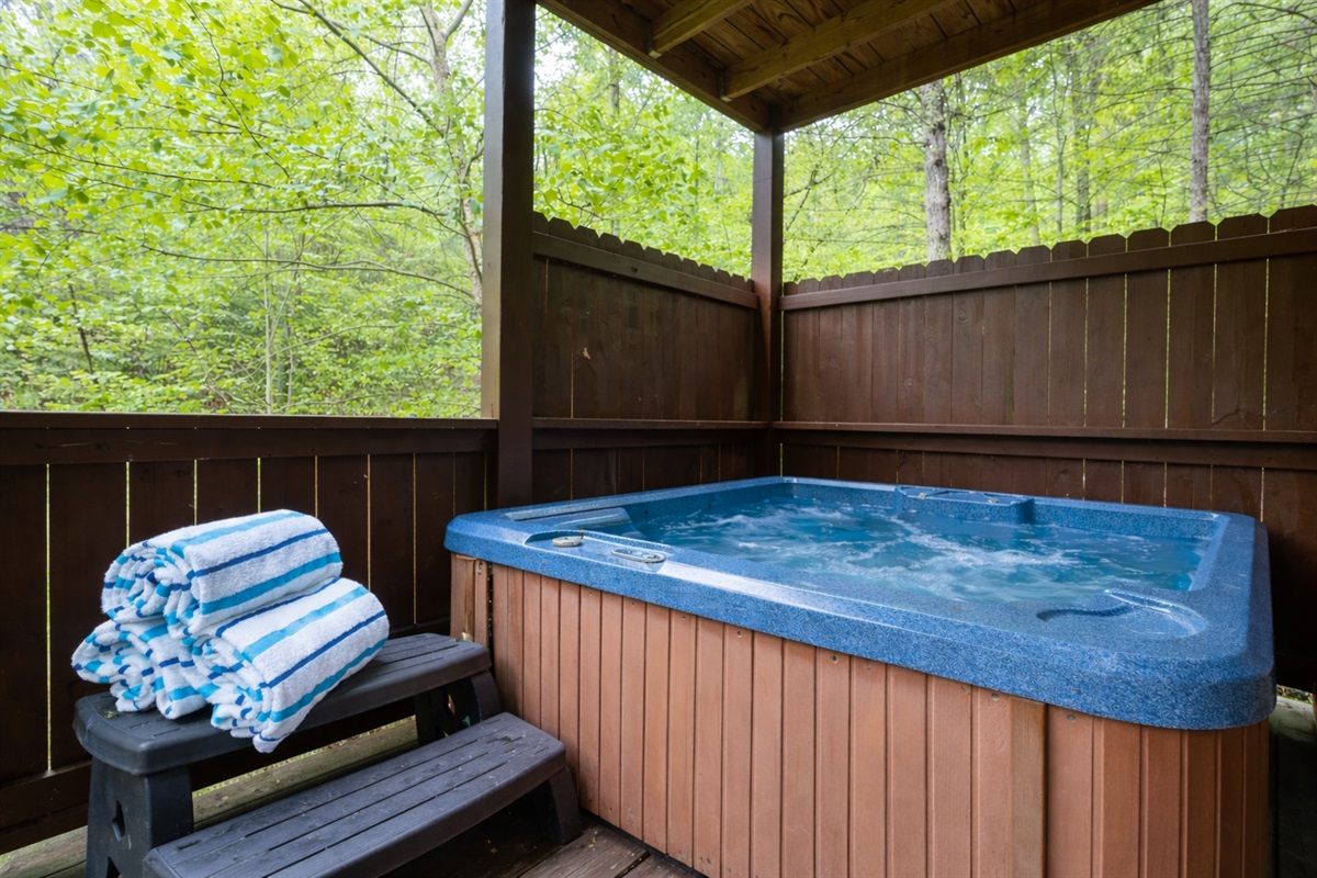 Soak in the private hot tub surrounded by peaceful Smoky Mountain woods