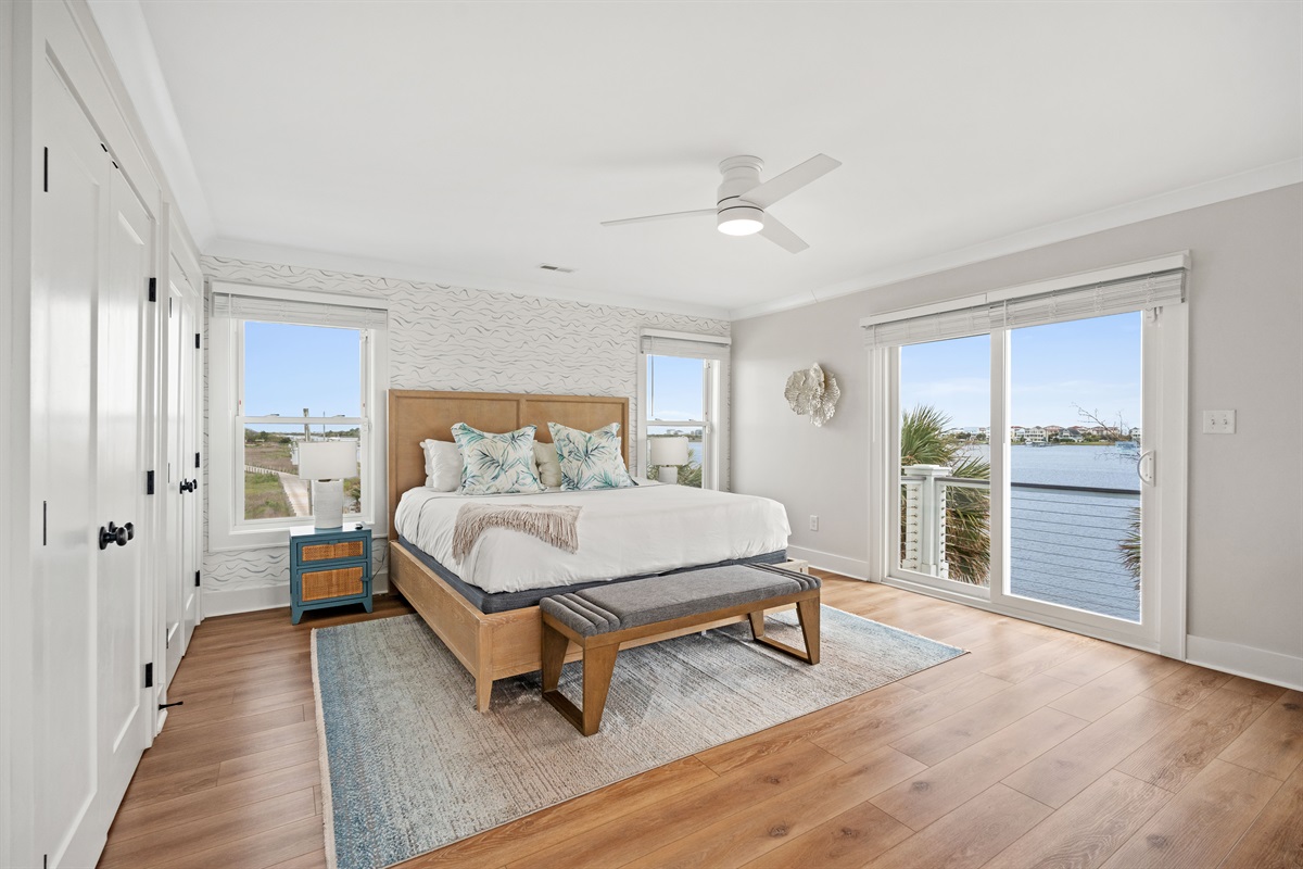 Bright and spacious 2nd-floor king bedroom featuring private balcony access and peaceful water views