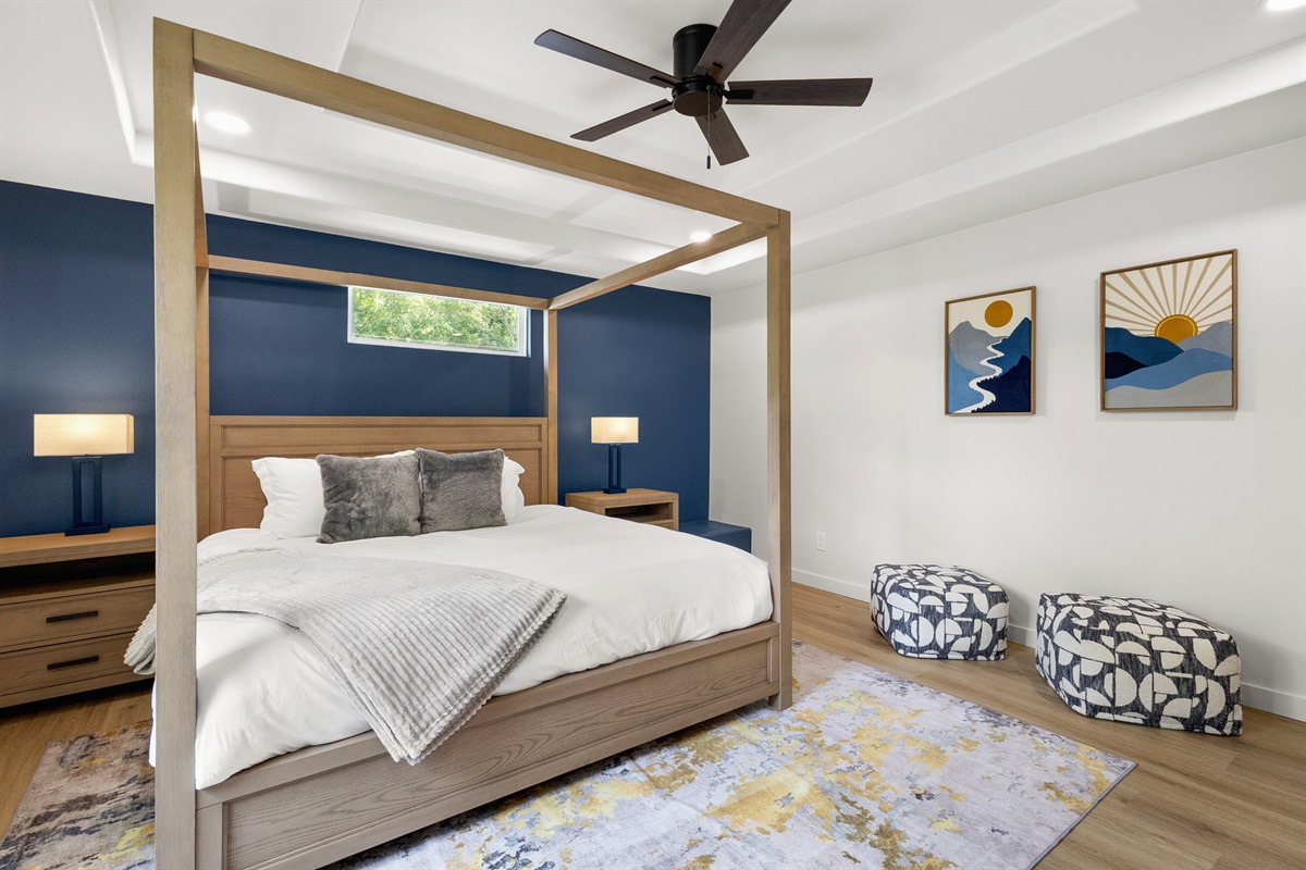 Stylish four-poster bed and artful decor create an inviting retreat in Austin!