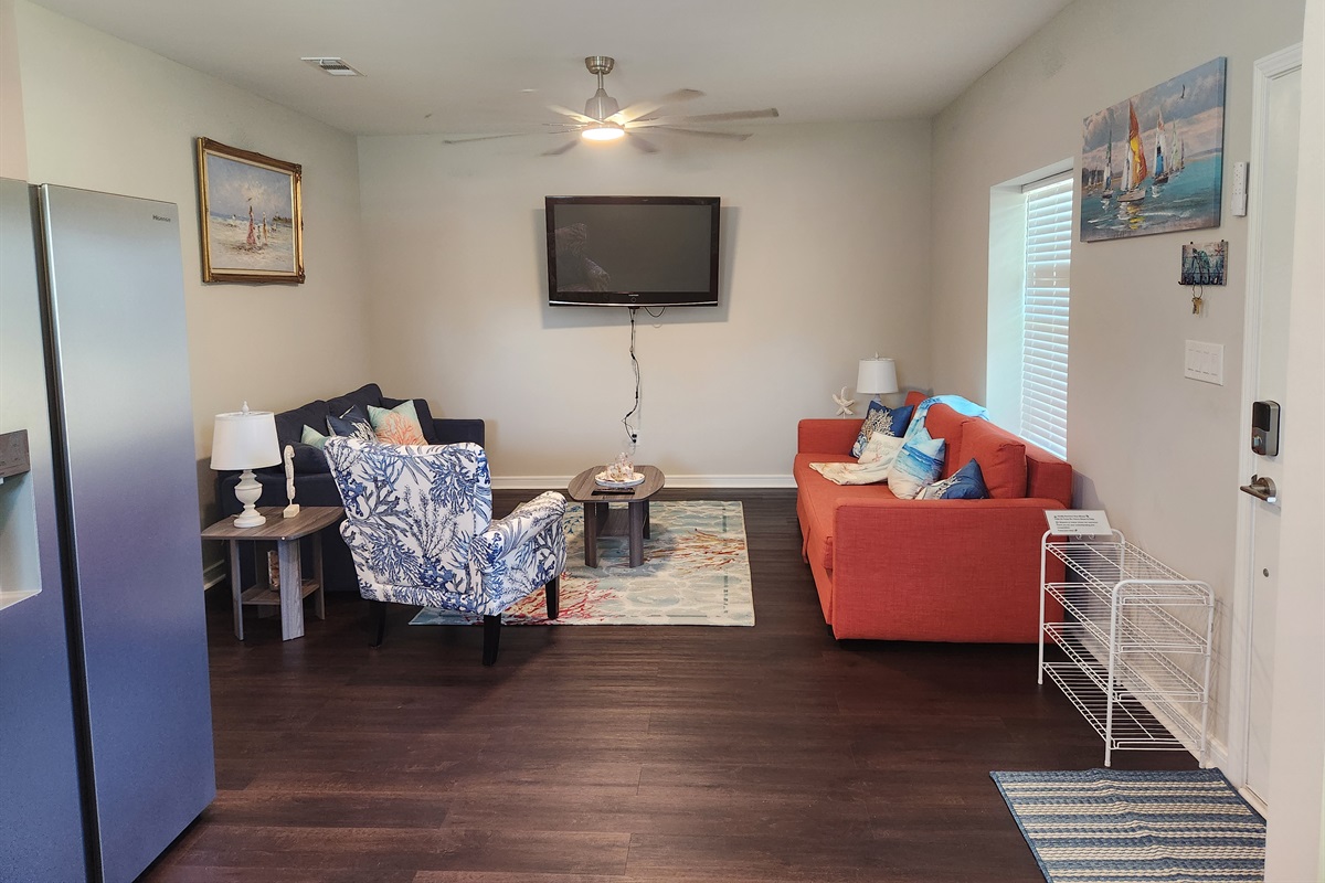 With plenty of comfy seating and a mounted TV for movie nights, this space is designed for connection, comfort, and fun