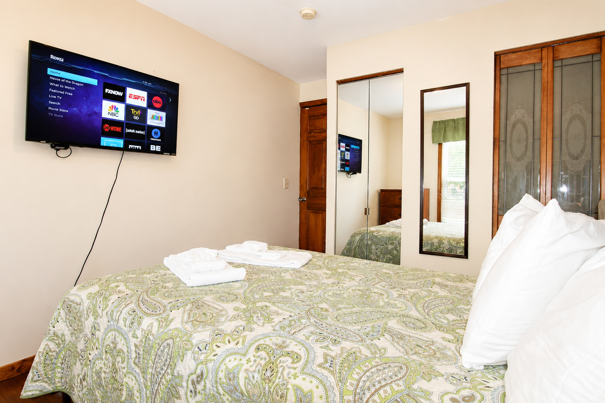 Bedroom #1 with a 43" (or larger) wall mounted flat screen smart Roku TV