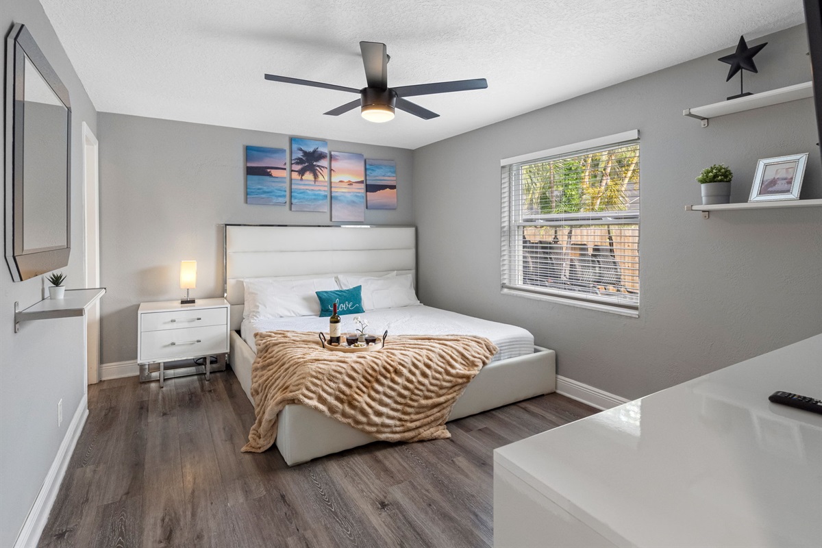 From the plush faux fur throw to the designer headboard and mounted flat-screen TV, every element is thoughtfully selected for comfort and sophistication.