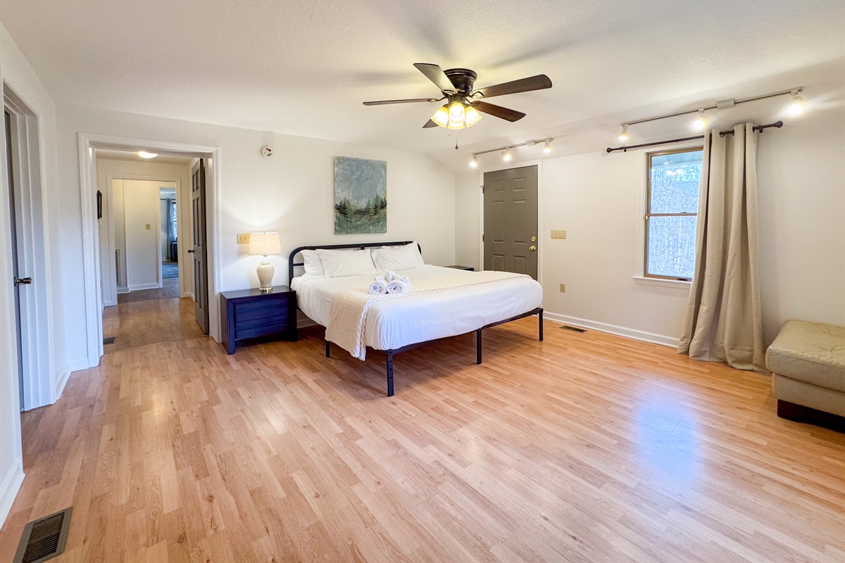 The master bedroom features a king size bed, large space, closet, and ensuite bathroom with accessibility features.