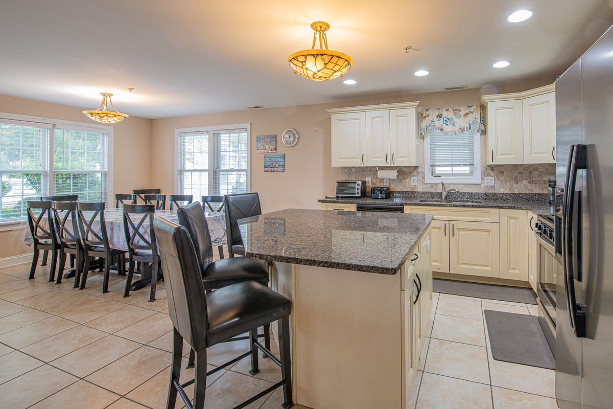 Fully Equipped Kitchen with Granite Countertops, Island, and Breakfast Bar Seating