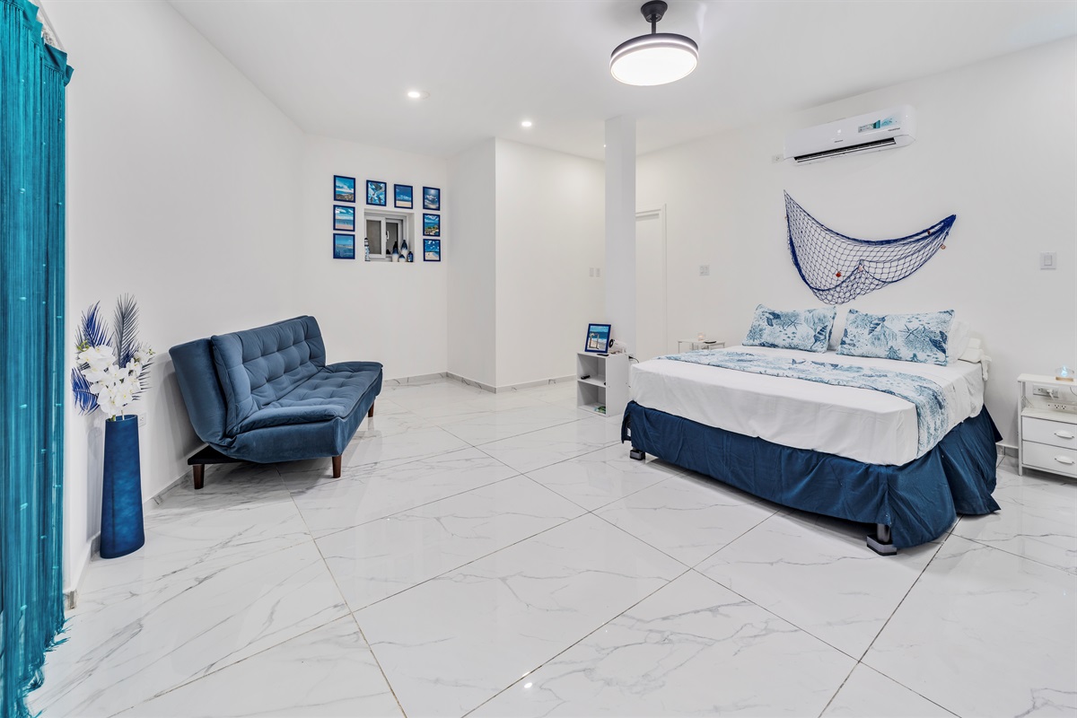 Marine-themed bedroom: King bed and convertible sofa in a spacious layout