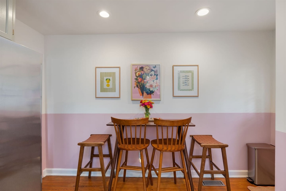 Kitchen features a pub table for dining and gathering around for snacks, drinks, coffee, or meals.