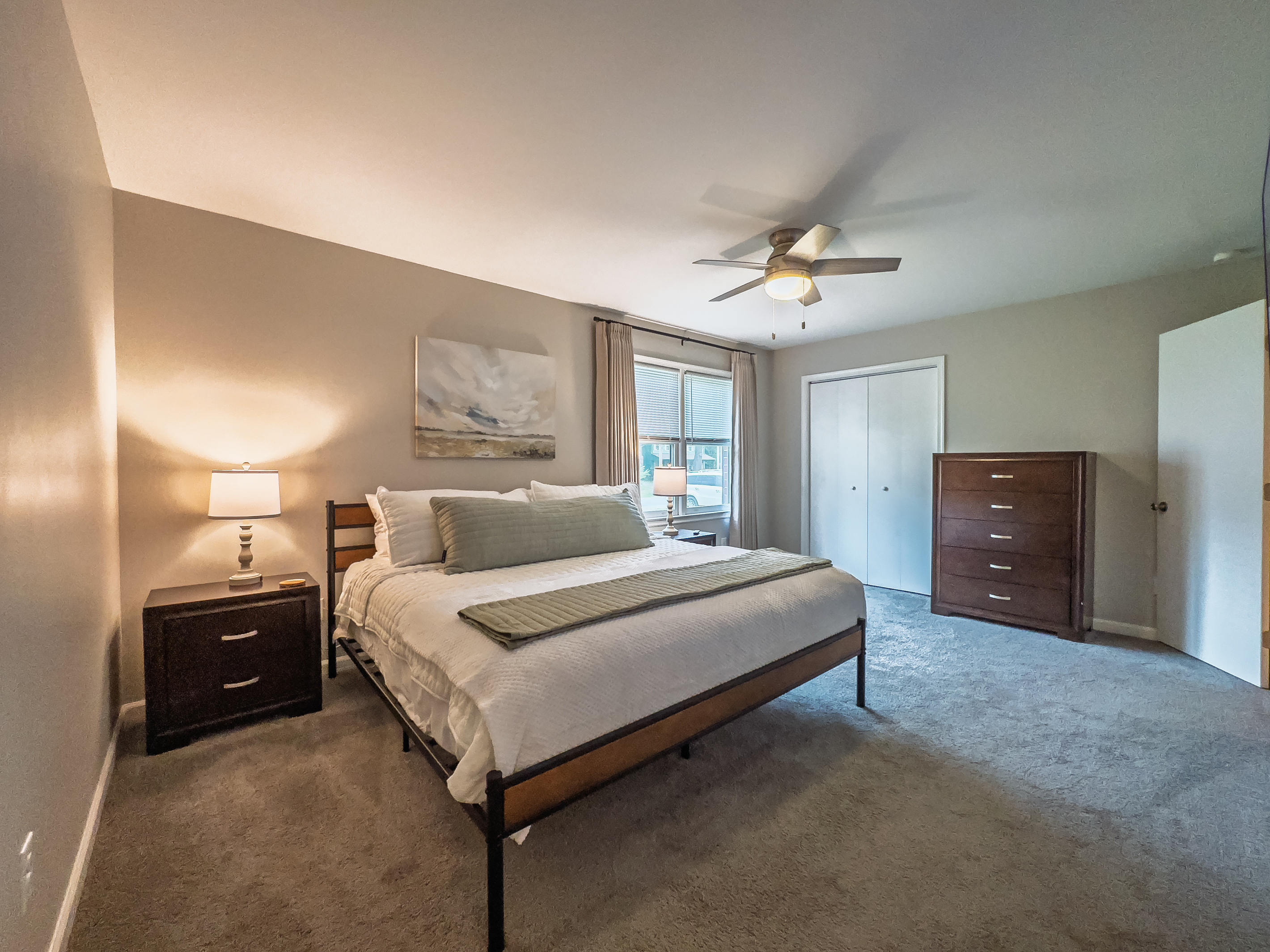 Primary Bedroom, King bed, 55" Smart TV, ceiling fan, two led light nightstands with multiple charging ports, two multi light function lamps, blackout curtains, dresser and closet, private full bathroom.