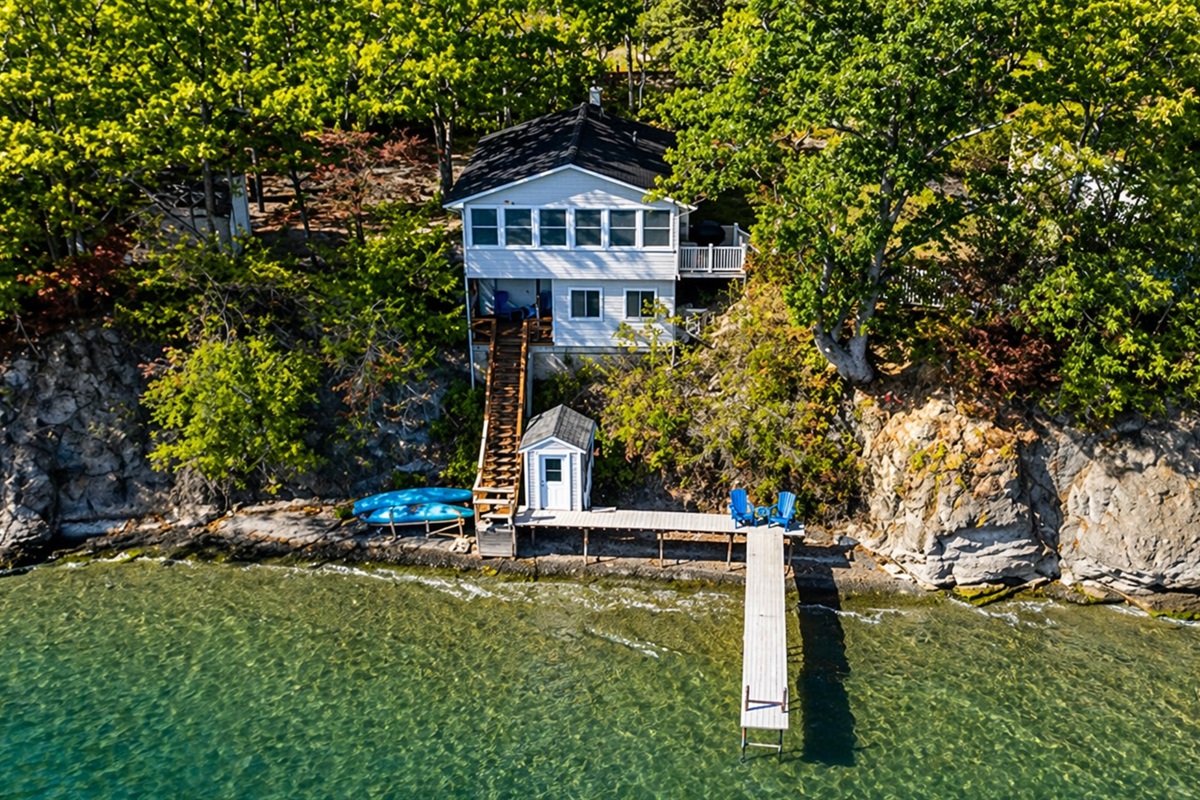 Iconic blue lake house perched above the dock—unmatched water views from every angle