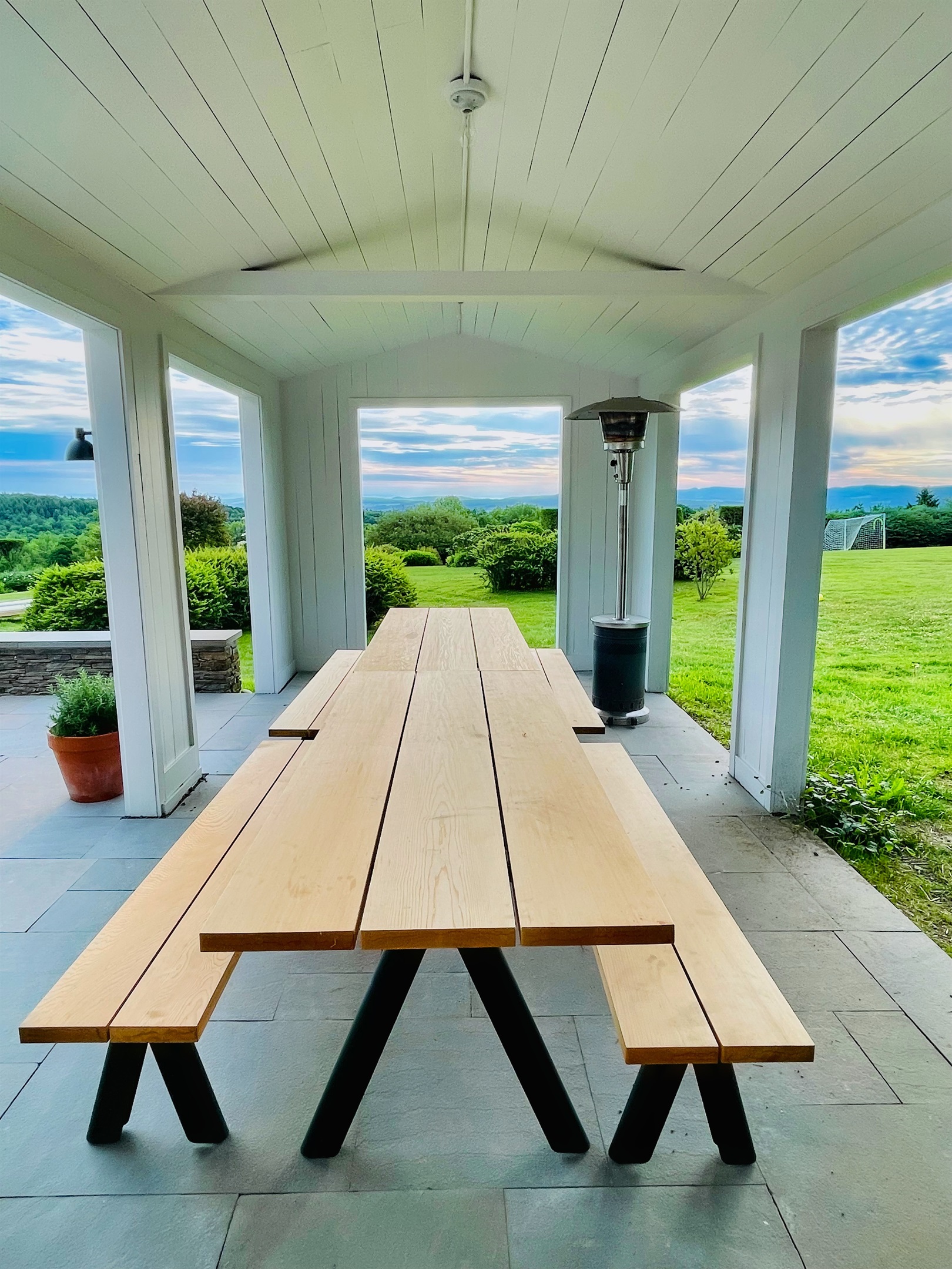 Hawk Field House - outdoor dining table with a roof so you can still enjoy the outdoors if its raining.
