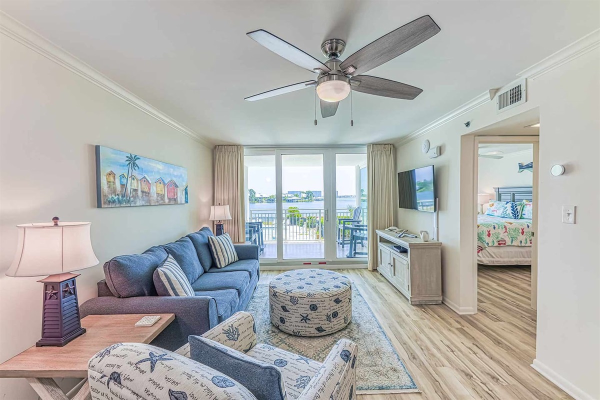 Living Room: Breathtaking bay views and comfy beach-inspired decor for your perfect retreat!