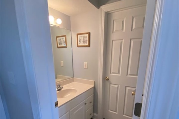 1st floor half bath and door that leads outside to the private pool, hot tub and tiki bar.