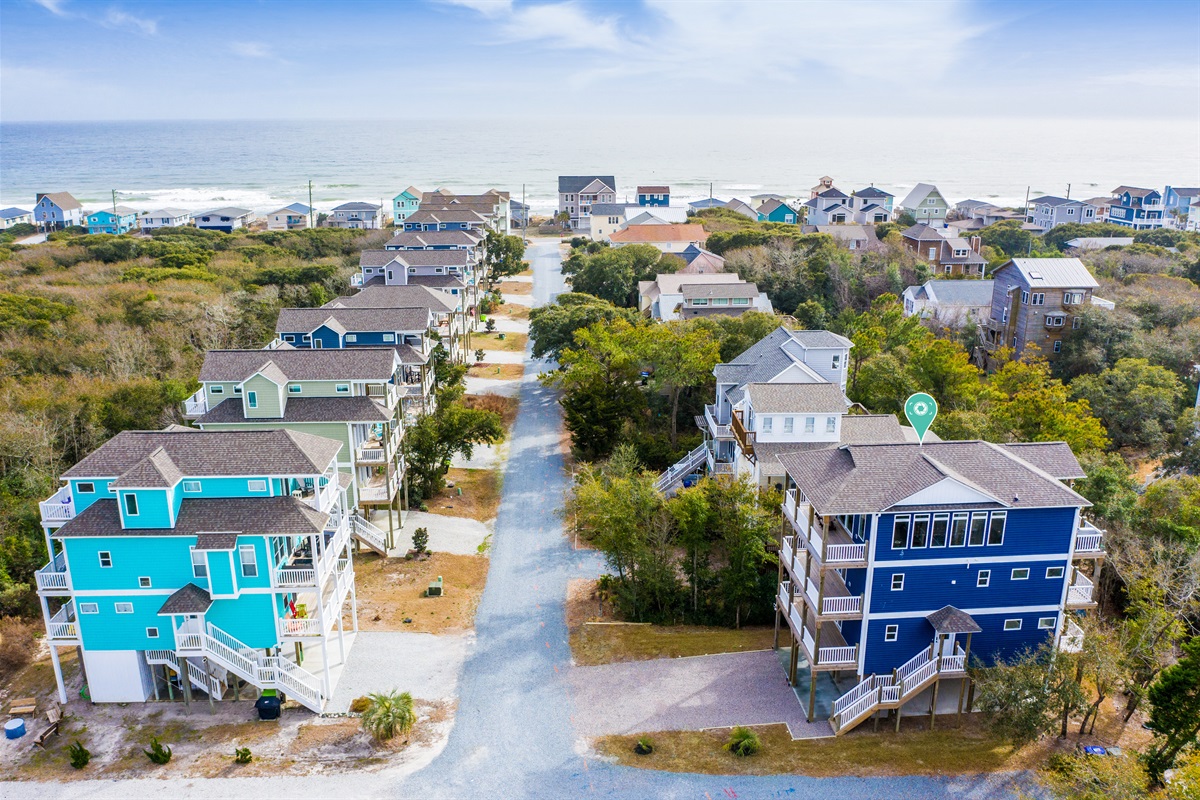 Drone views showcase the house, neighborhood streets, and proximity to the beautiful Topsail Island beaches