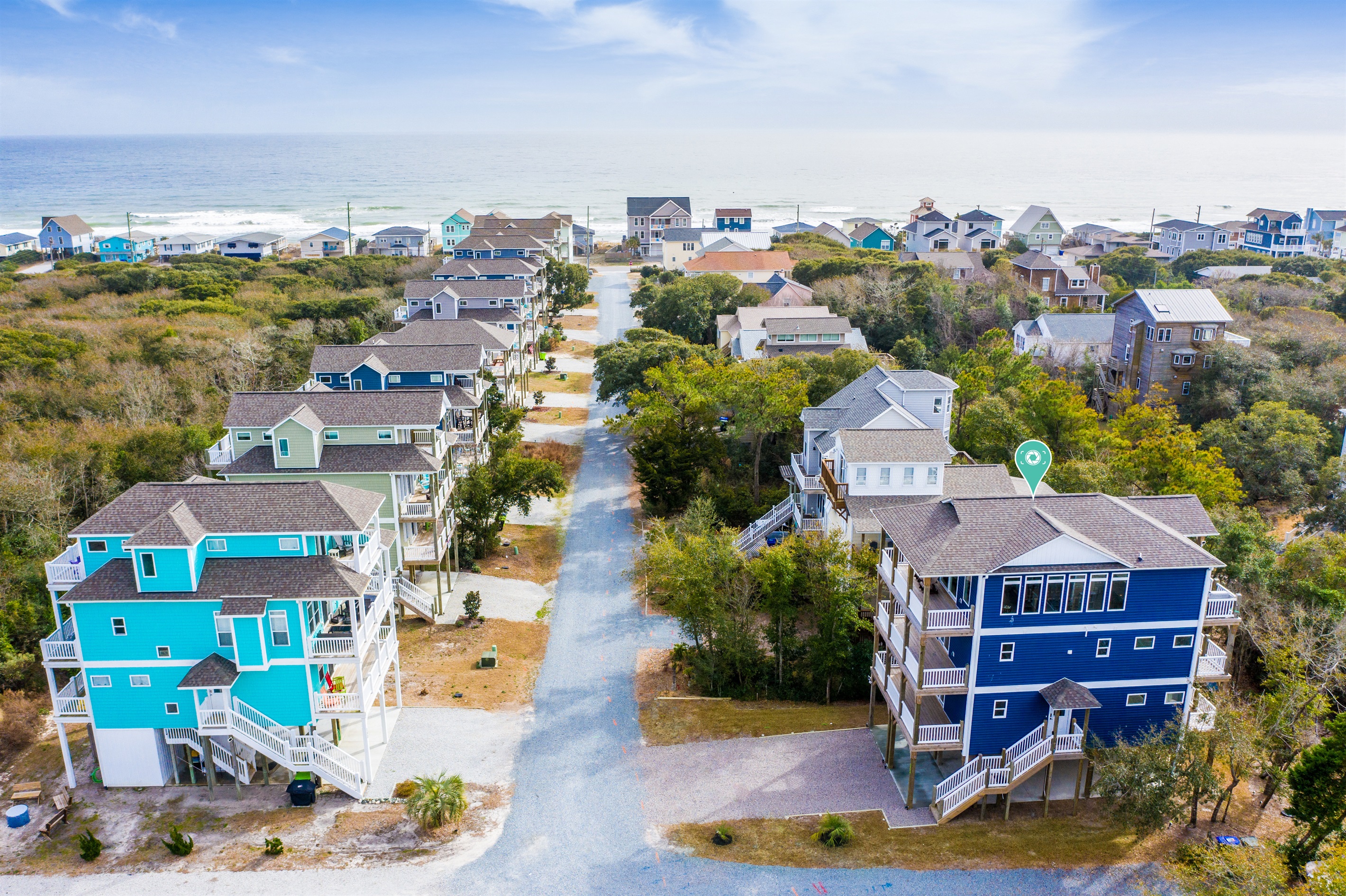 Drone views showcase the house, neighborhood streets, and proximity to the beautiful Topsail Island beaches