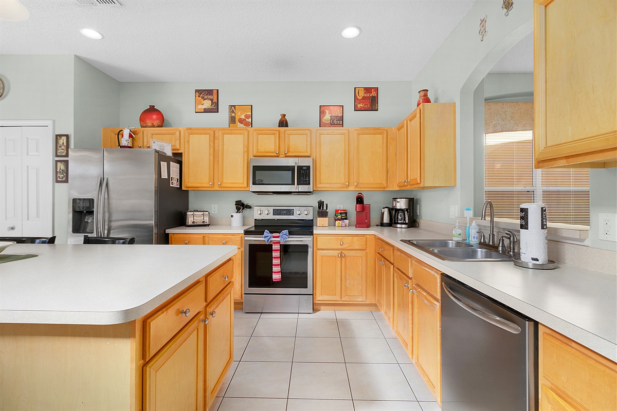 Modern, open kitchen with stainless steel appliances.