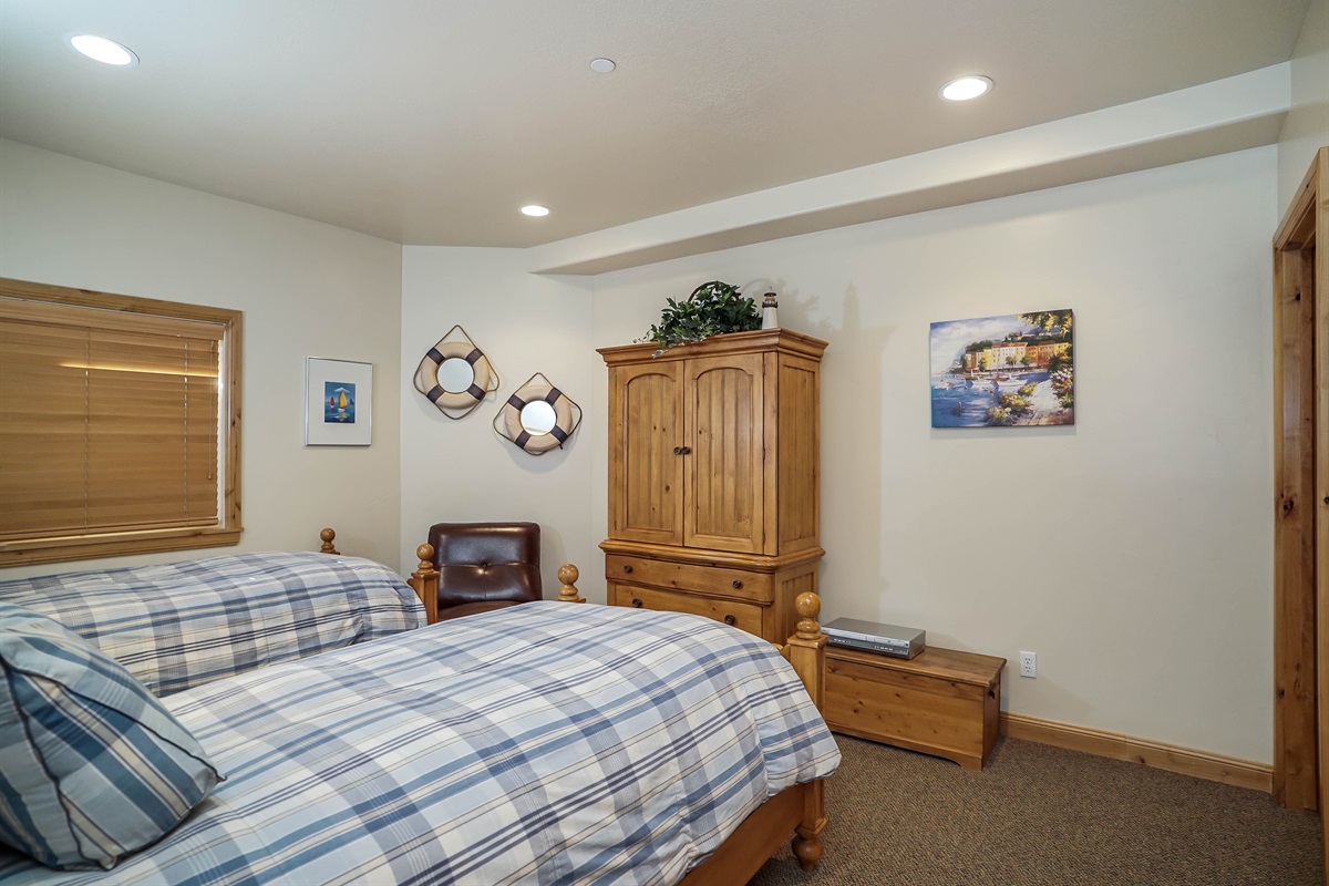 Comfortable guest bedroom with inviting bedding and warm tones.