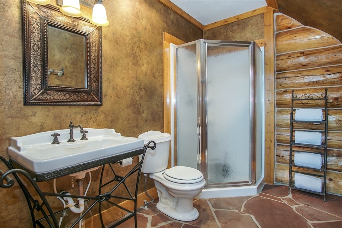 Full bathroom with walk-in shower and rustic charm