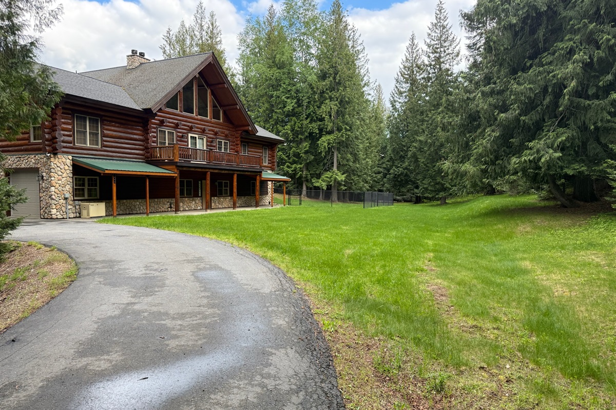 Drive up to cabin, arrive at back of cabin with view of large private lawn