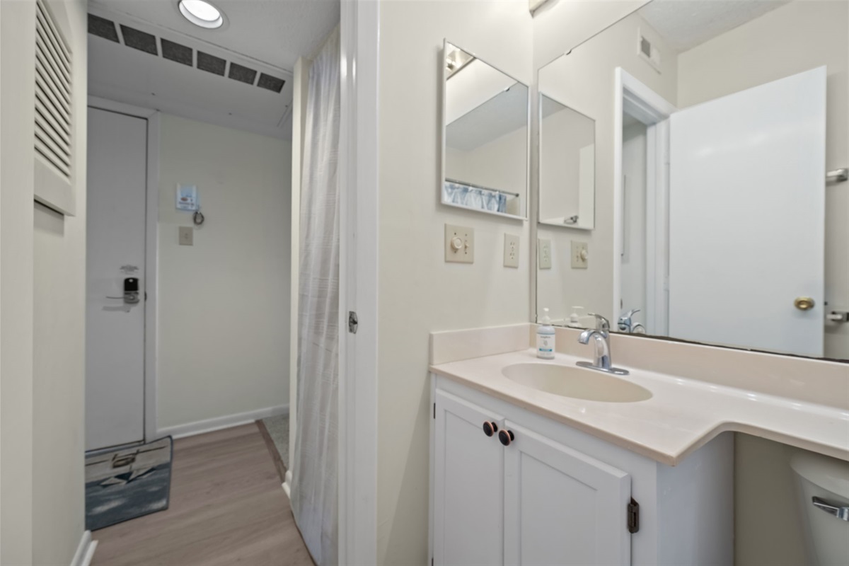 Convenient vanity area just off the entry, perfect for quick touch-ups or rinsing off after a sandy day out