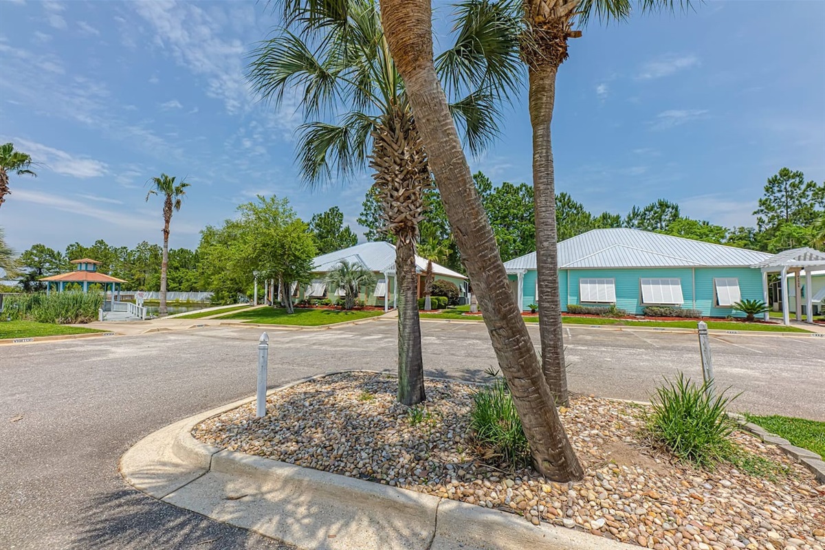 Exterior Paradise: Relax amidst swaying palms and lush landscaping in vibrant Orange Beach!