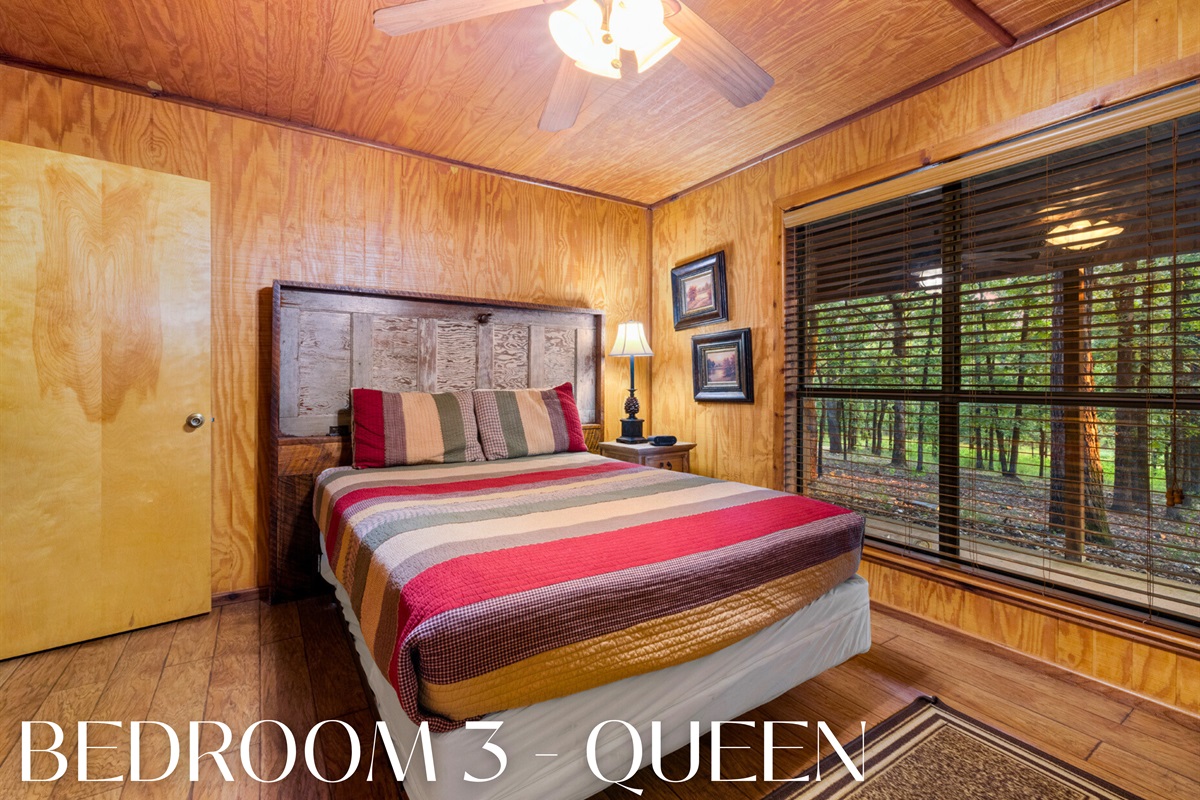 Bedroom with queen bed and rustic style.
