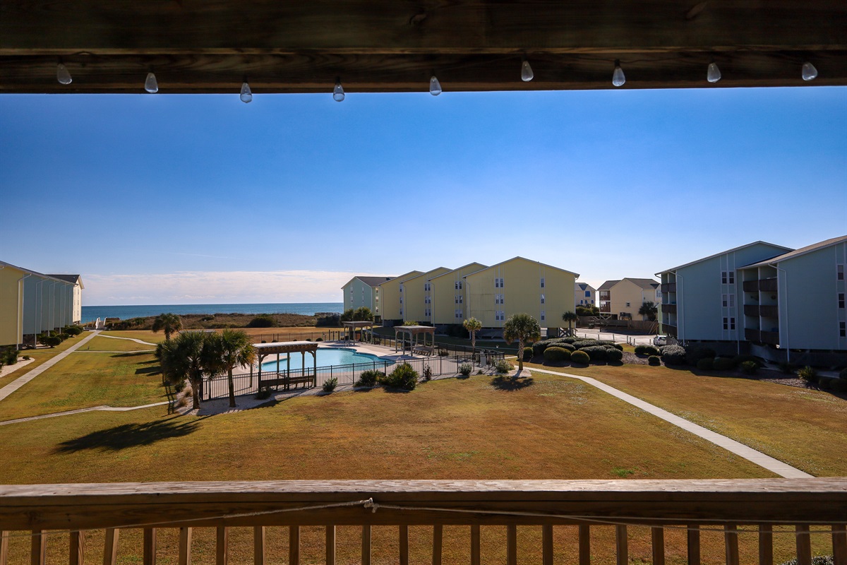 Wide open views of the pool, spacious courtyard, and the ocean just beyond the dunes