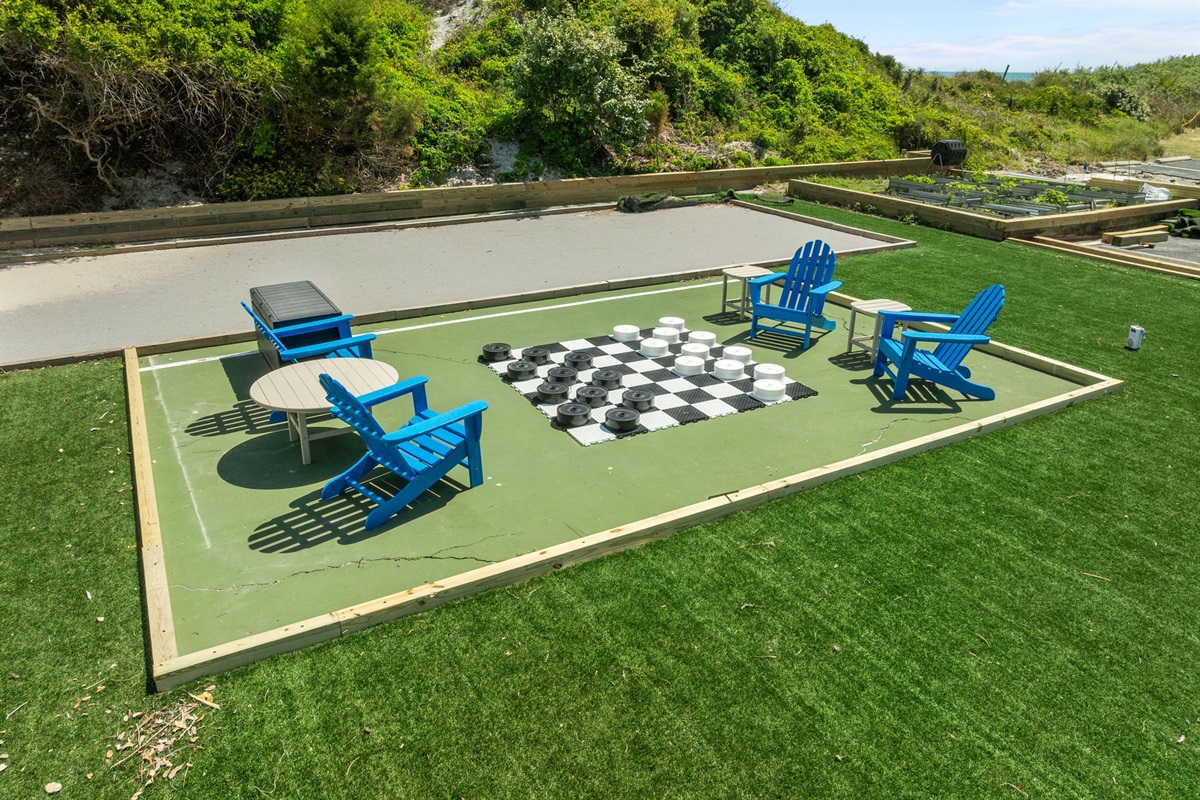 Outdoor games area featuring oversized checkers and seating