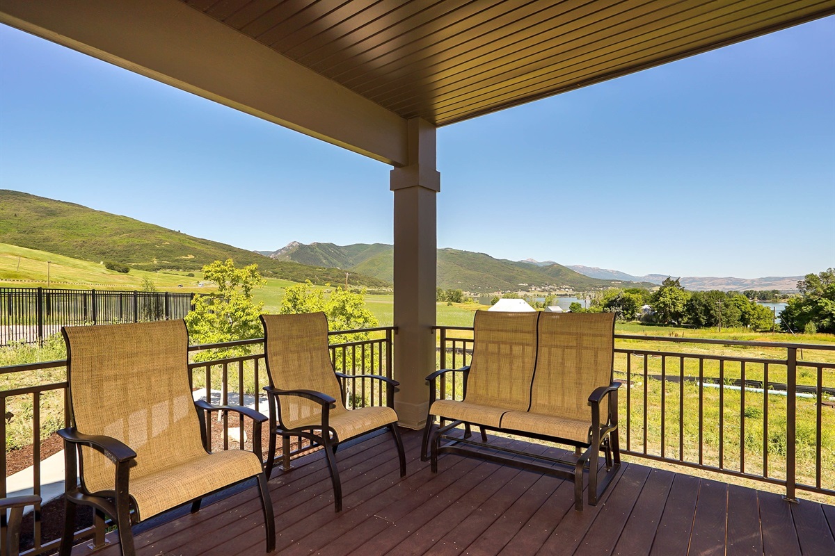 Covered deck with seating and stunning mountain views.