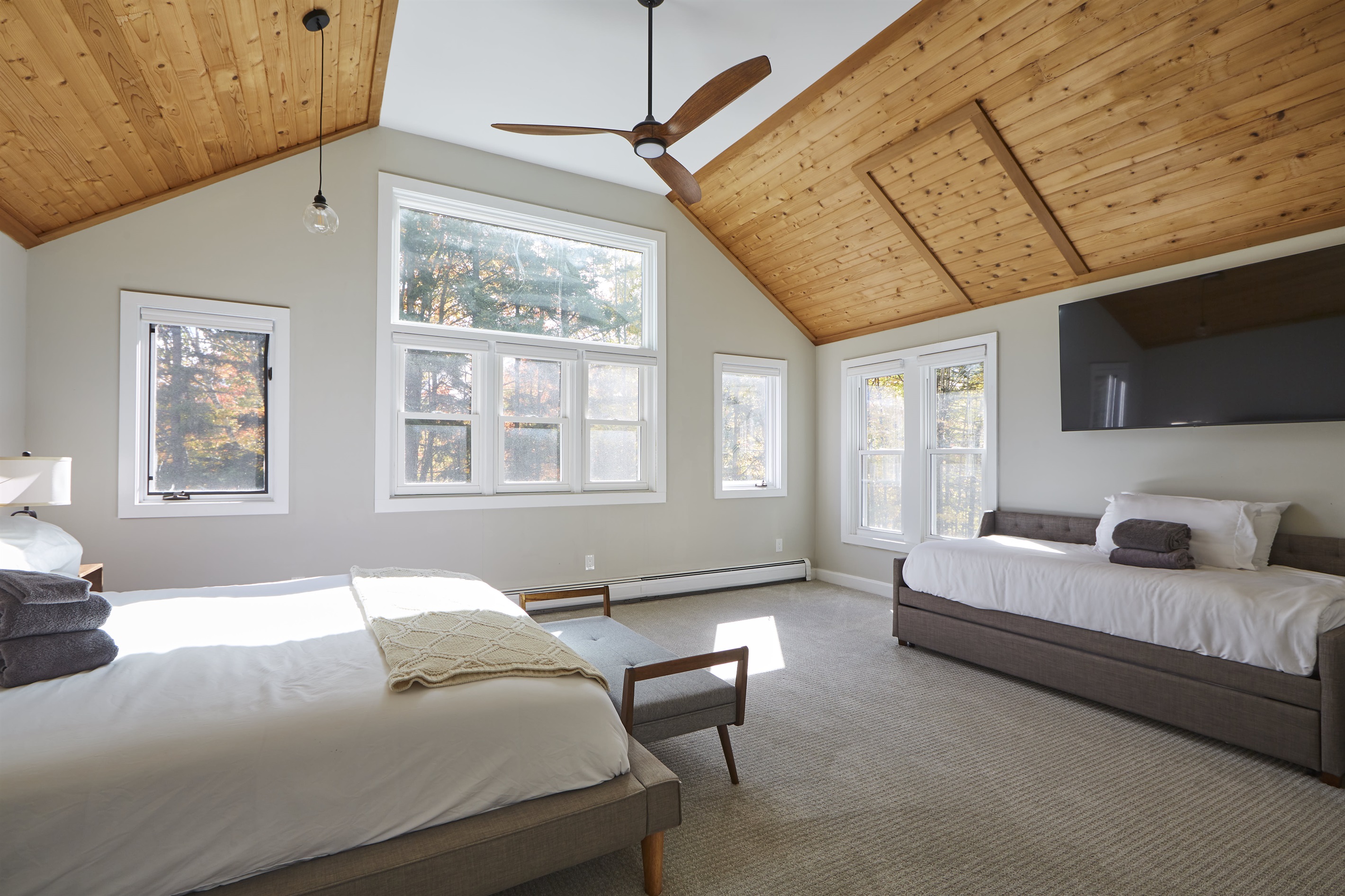 The second-floor master bedroom is bathed in natural light from the skylights and features a beautifully renovated en-suite bathroom for a touch of luxury.