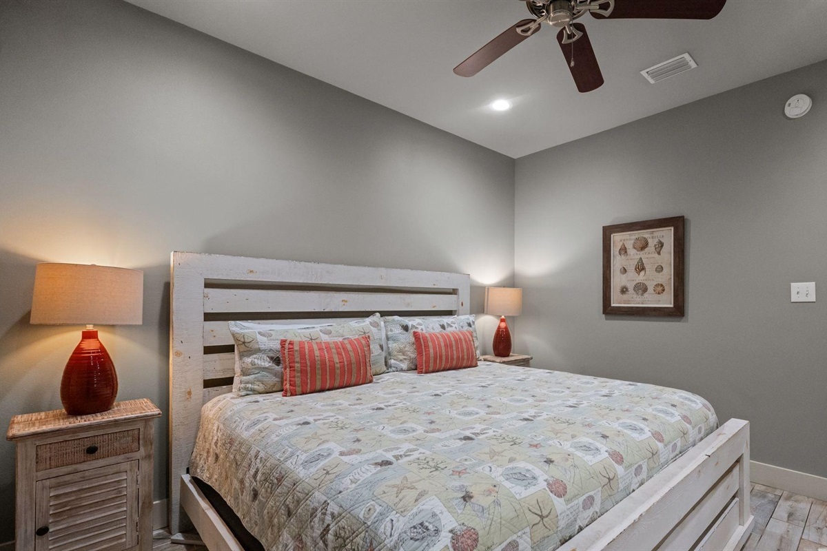 Bedroom with king bed, ceiling fan, TV and en-suite bathroom 