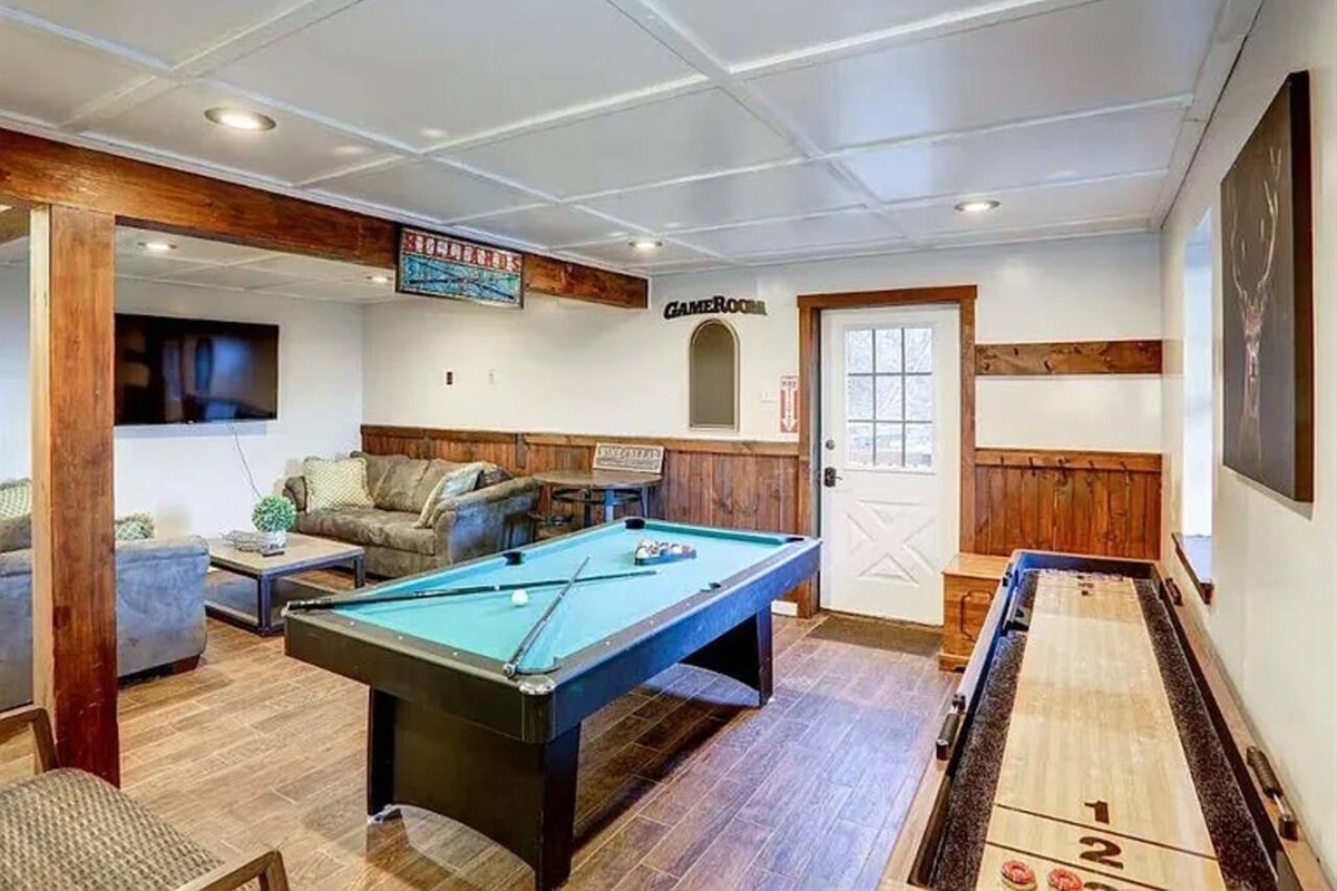 Game room / play area with pool table and shuffle board