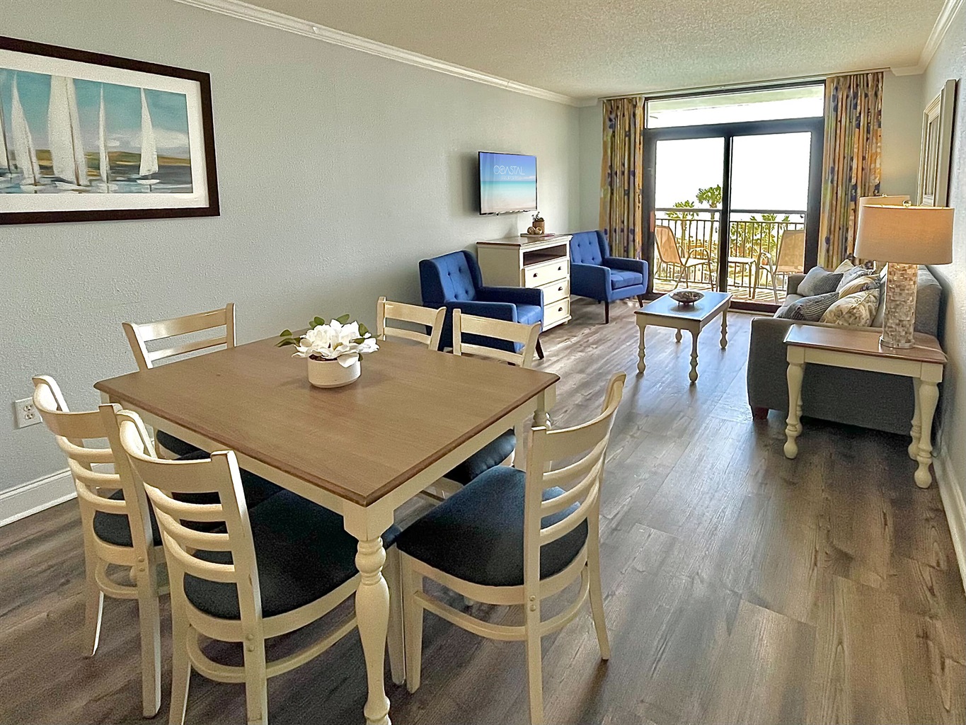 Feast your eyes on the perfect blend of elegance and coastal charm in this dining area and spacious living area for moments of indulgence!