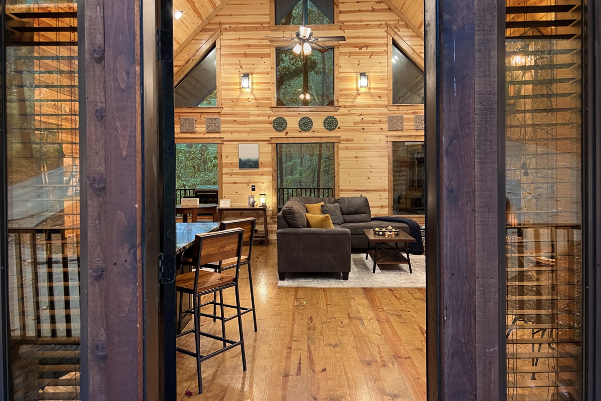 There are picture windows to enjoy the forest from the open concept living/dining/kitchen area.
