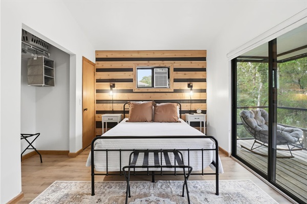 Upstairs queen bedroom with private balcony and Roku TV