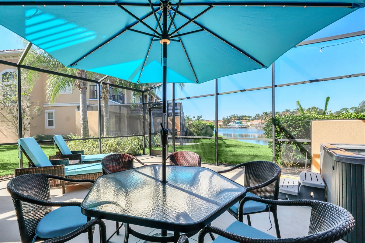 Private covered lanai with lounge area, dining area and hot tub