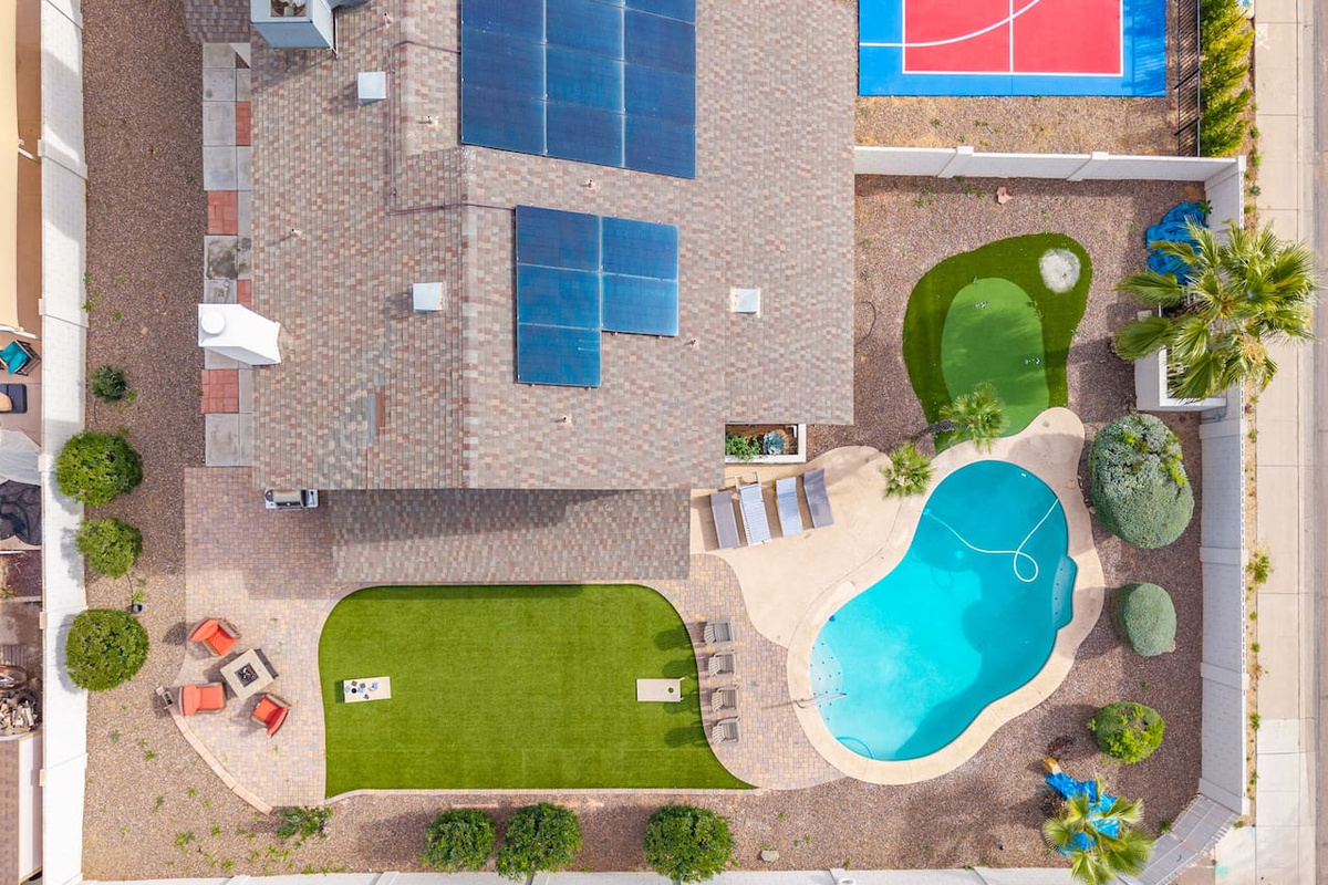 Urban backyard retreat with resort pool, sports court, putting green, and expansive lawn.