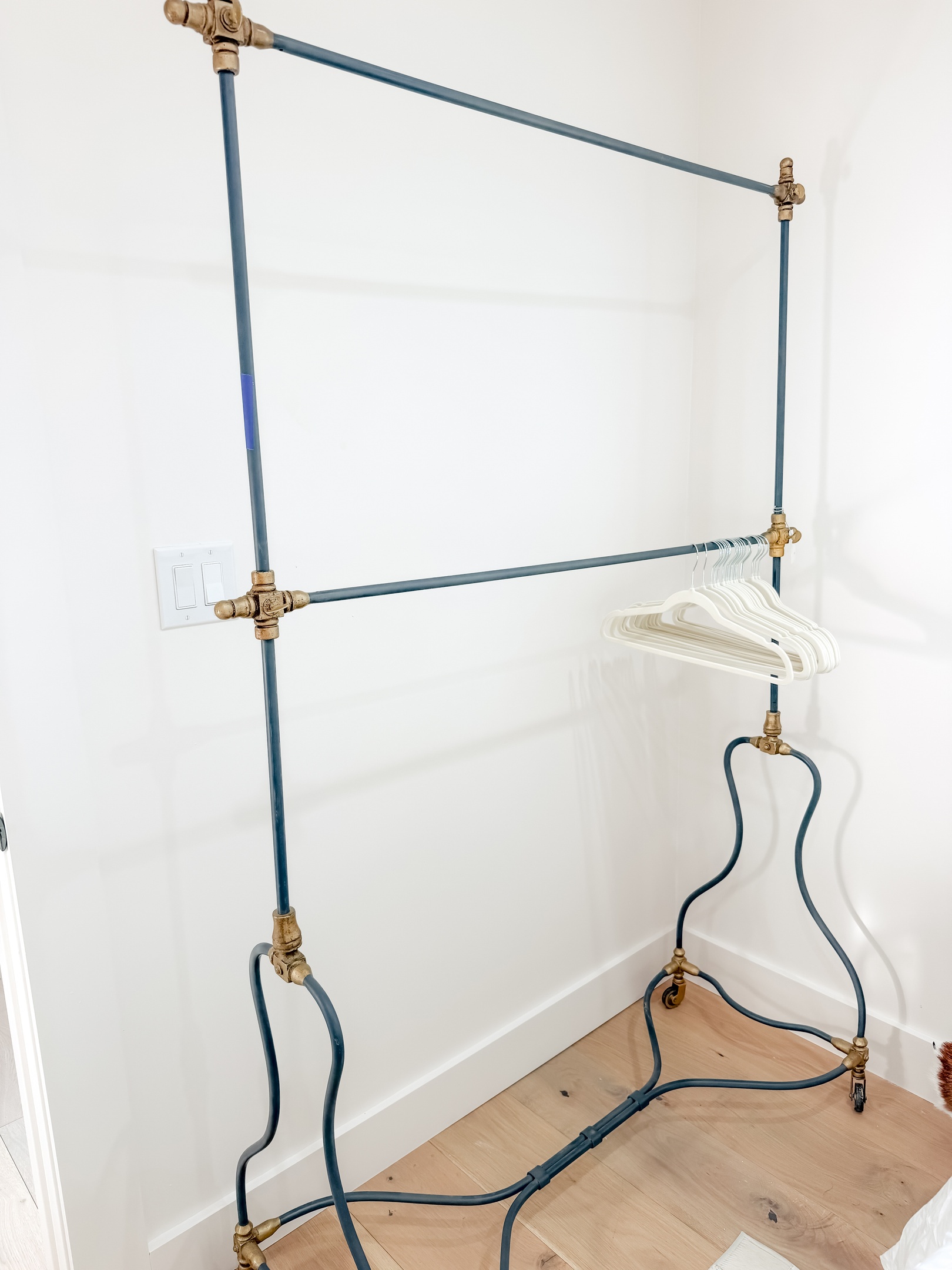 A vintage-style clothing hooks provide a convenient place to hang garments and accessories.