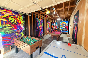 Full-size pool table in the blacklight game room garage
