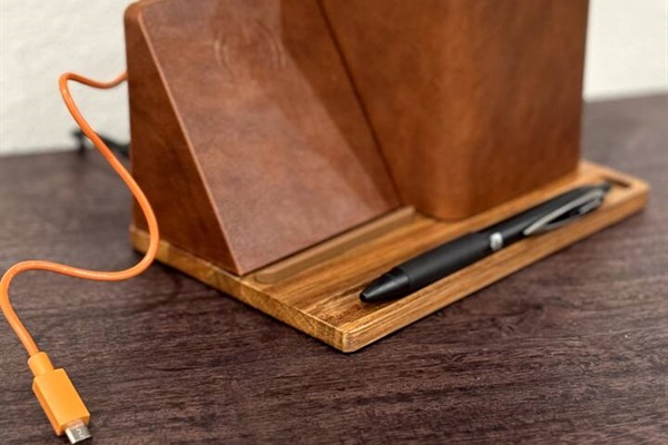 Charging station includes contact charging as well as two USB ports in the back and a pencil/pen holder.