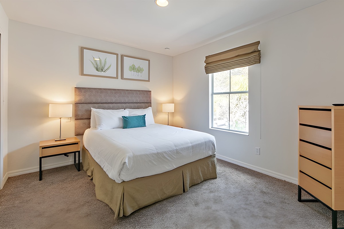 This bedroom has a very comfortable queen bed