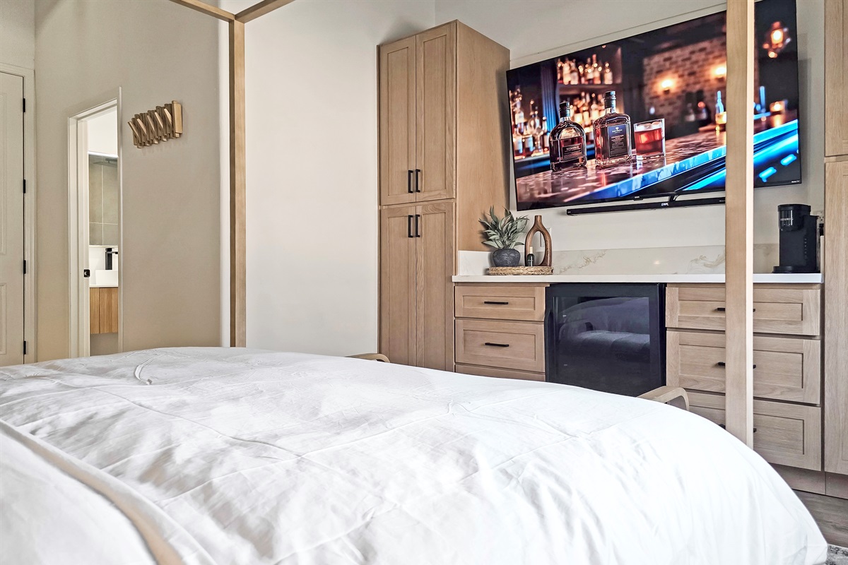 Beverage fridge, coffee maker and 75" smart tv with surround sound.