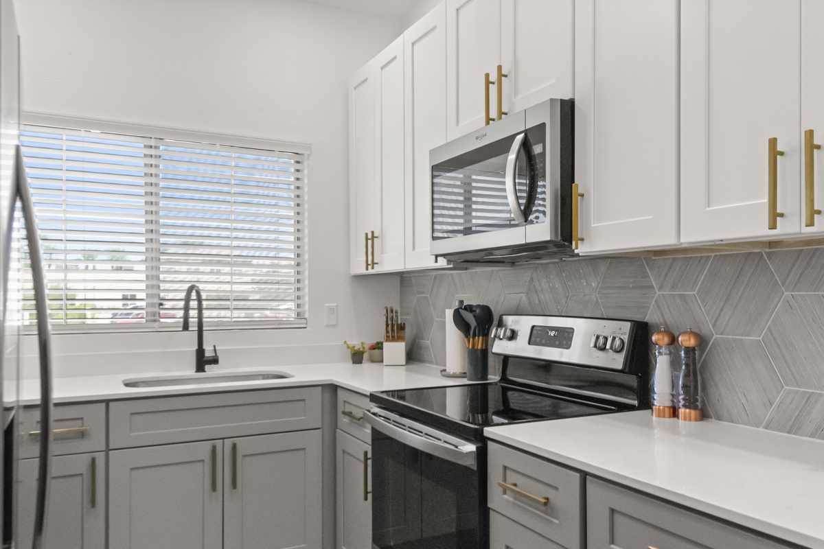 Bright modern kitchen with stainless steel appliances, a spacious layout, and ample counter space for preparing meals during your stay.
