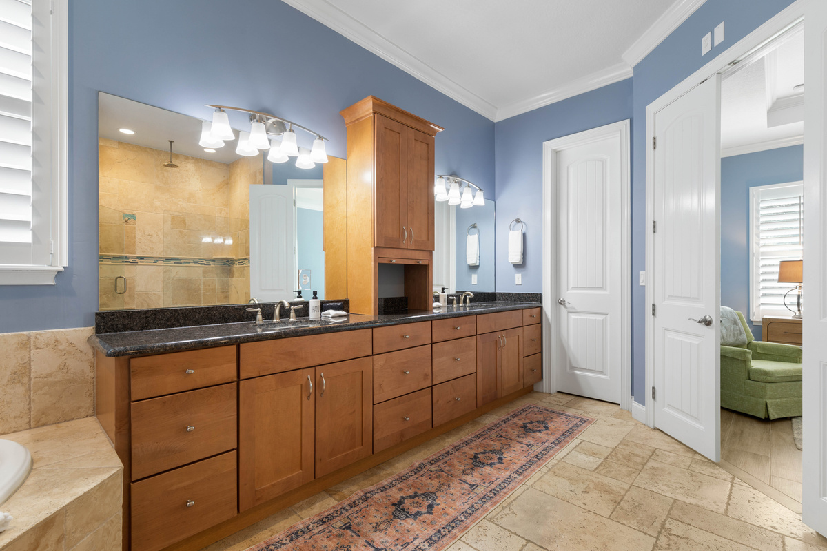 Two sinks, wide mirrors and a tall linen cabinet keep the Primary bath organized when two people get ready at once.
