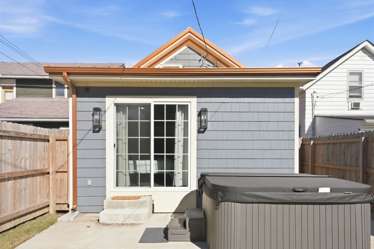 Private backyard patio with a relaxing hot tub, perfect for unwinding after a long day