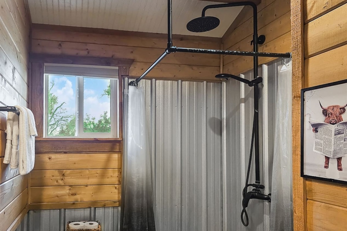 Rinse off in style—this spacious shower brings a touch of modern comfort to your rustic Texas retreat.